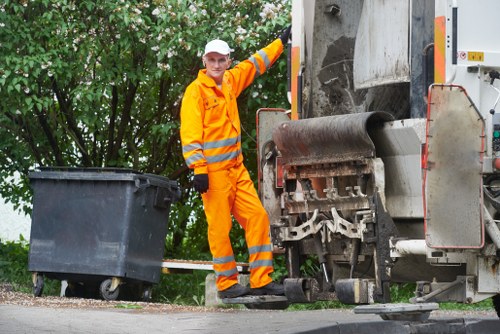 Large builder's skip being loaded with construction debris